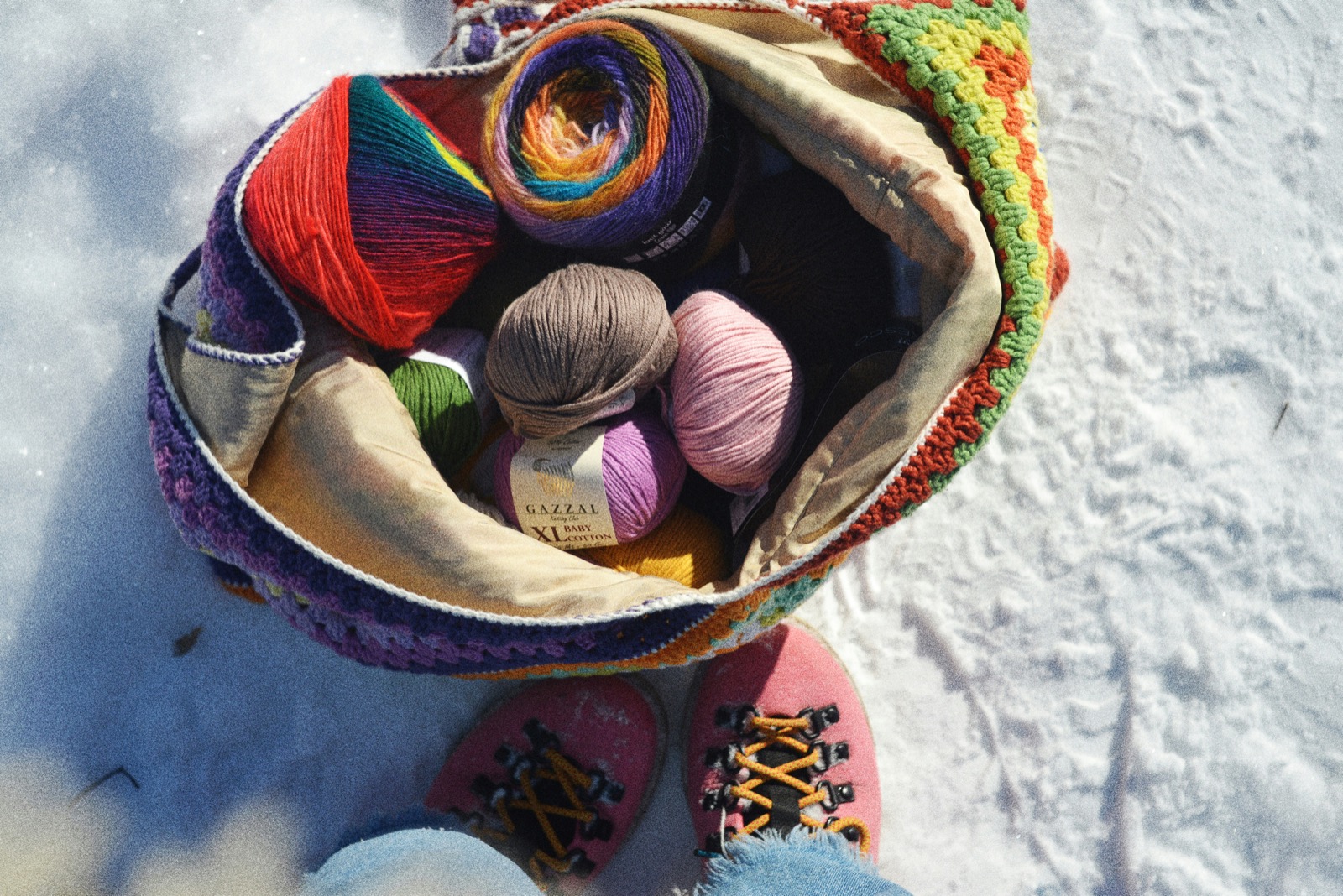 Colorful yarn stash in a handmade crocheted bag